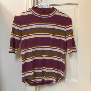 Short sleeved knit shirt with a low turtle neck